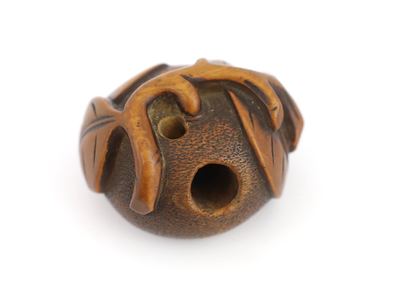 A Japanese carved wood netsuke of a pumpkin with a stalk and leaves, 19th century, signed Tomonoru